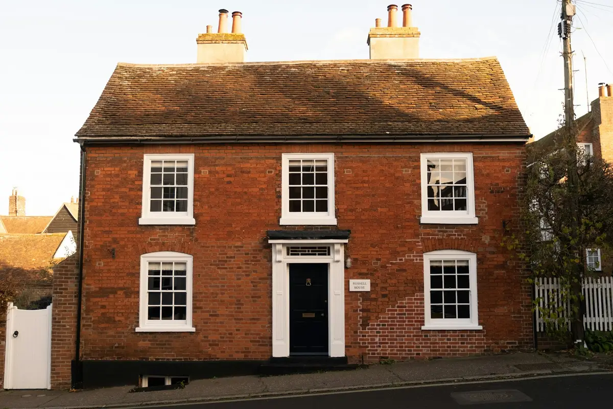 Red-brick detached house with white sash windows