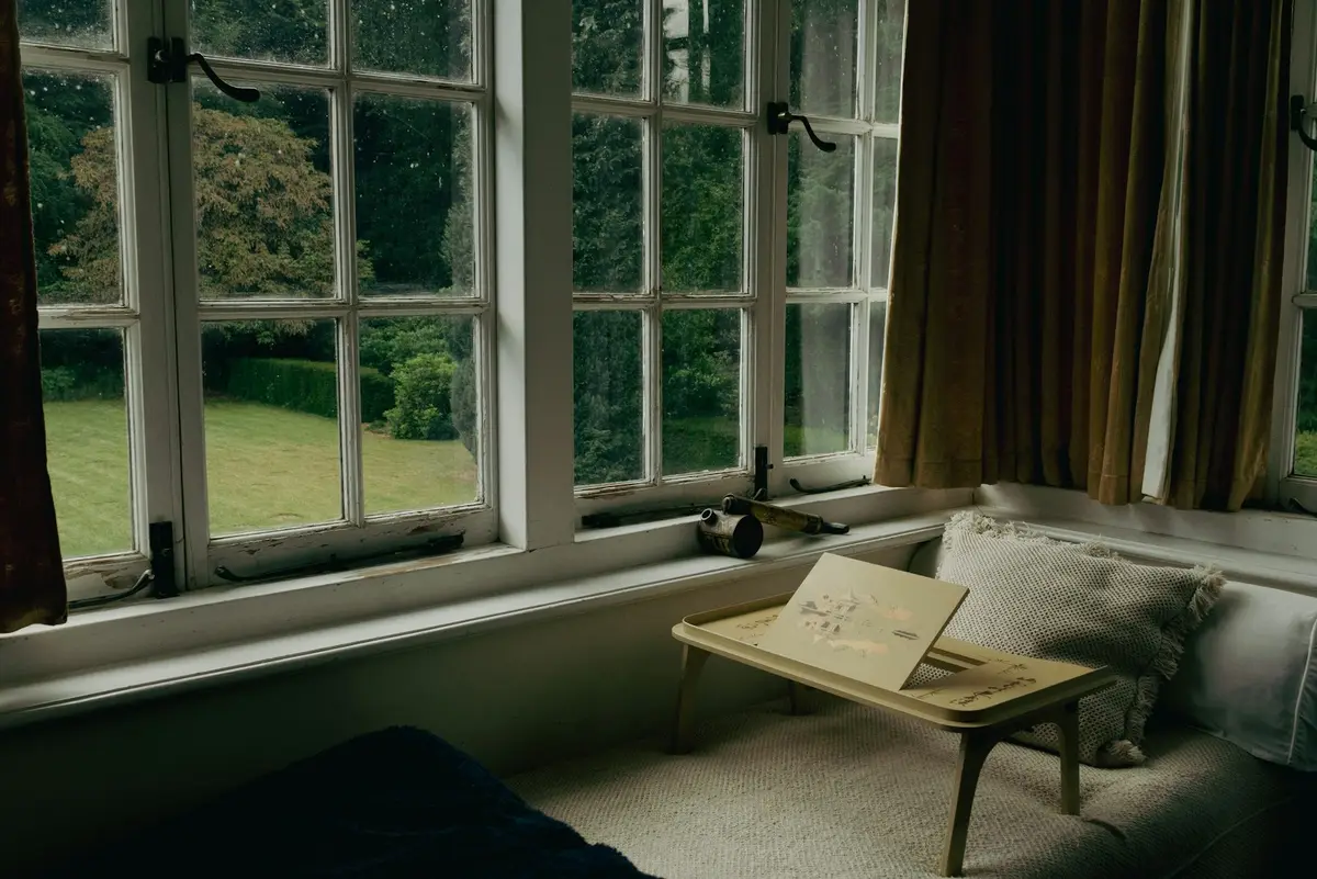 Large multi-pane casement windows opened wide on their stays